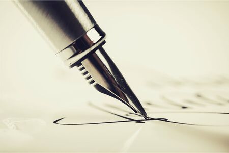 129756918-signing-a-signature-with-a-fountain-pen
